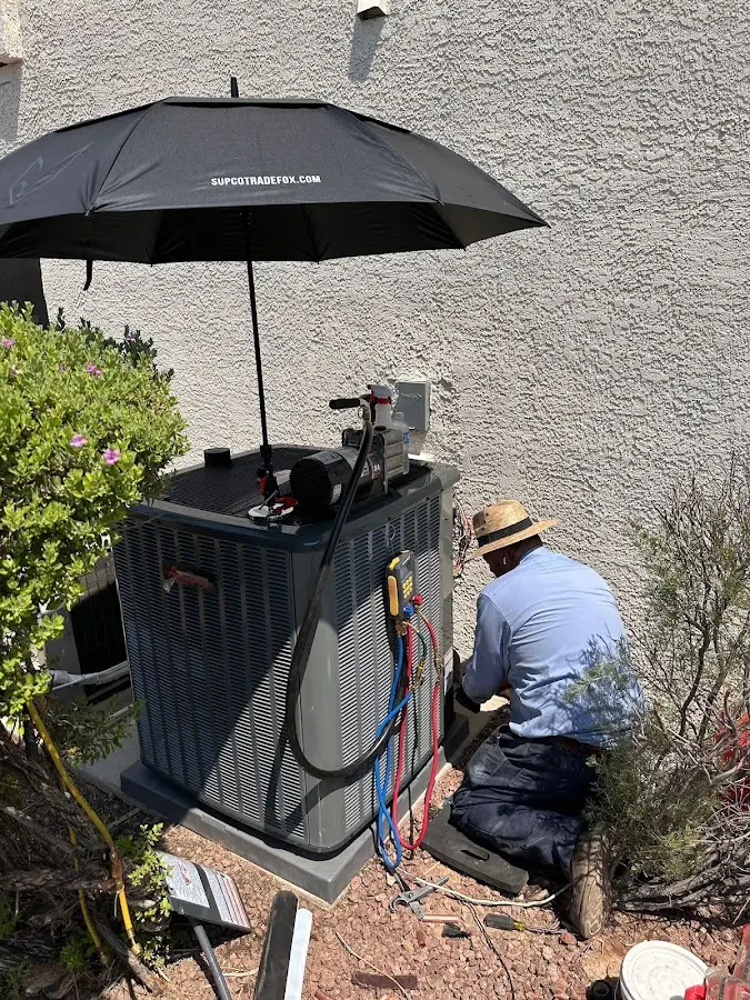 HVAC technician performing outdoor AC maintenance in Archer Lodge